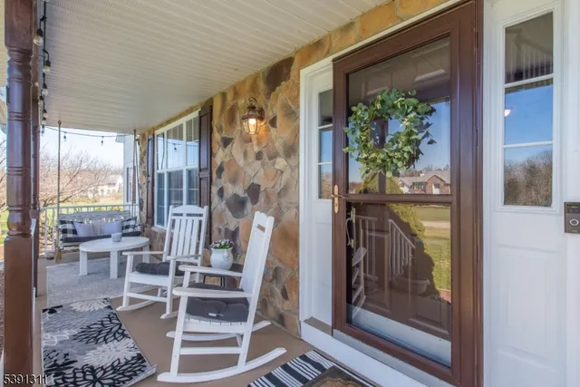 a view of a living room and dining room with wooden floor