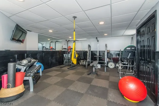 a view of a patio with table and chairs potted plants with wooden floor and fence