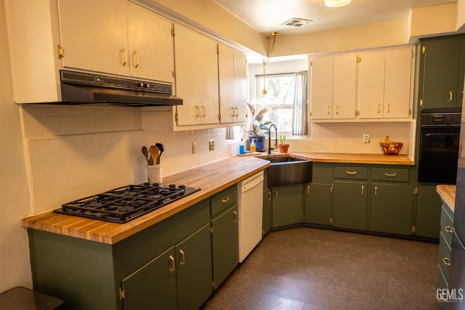 Undisclosed Address Tehachapi, CA 93561 - Photo 15 of 46 a kitchen with stainless steel appliances a sink stove and cabinets