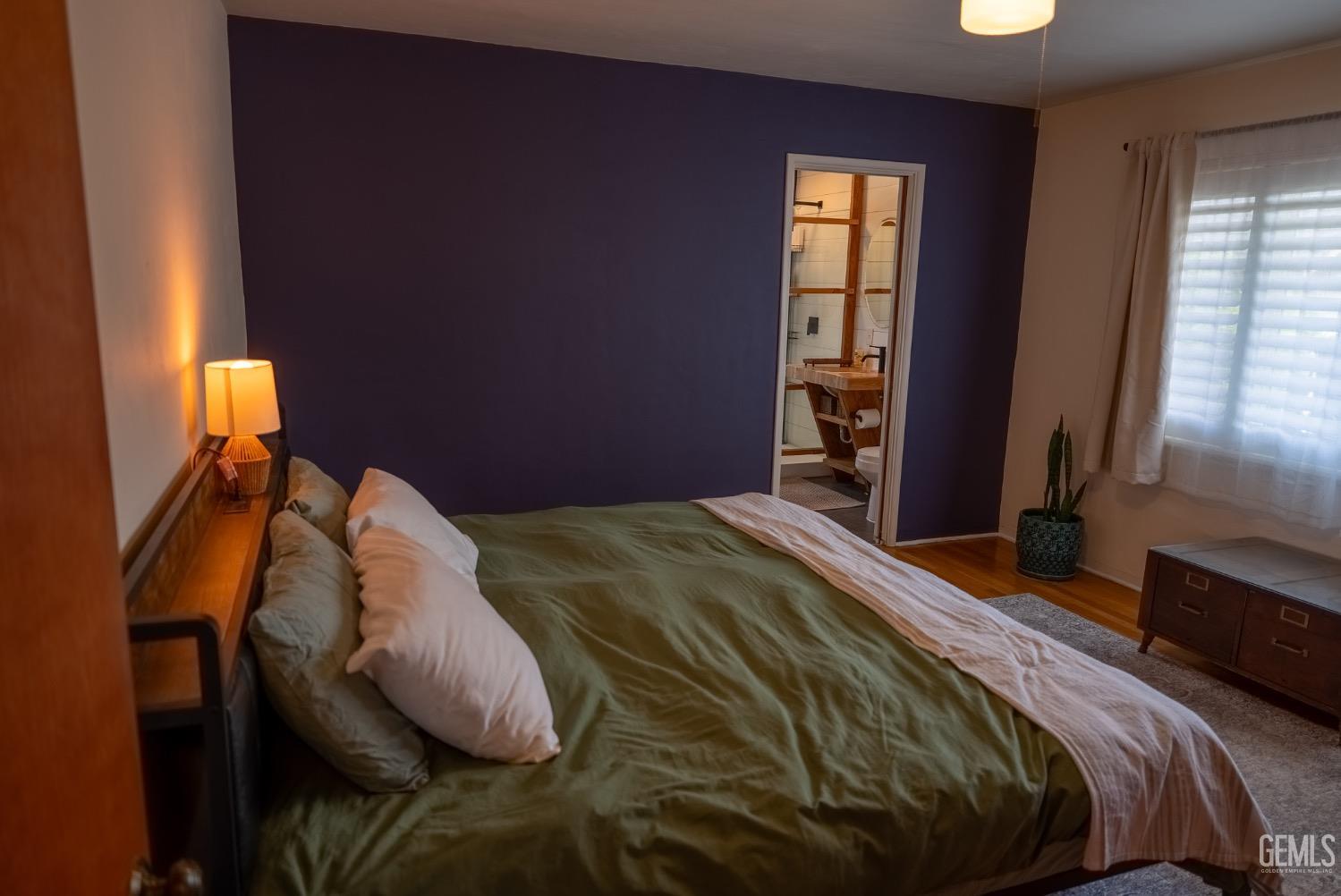 Undisclosed Address Tehachapi, CA 93561 - Photo 20 of 46 a bedroom with a bed and wooden floor