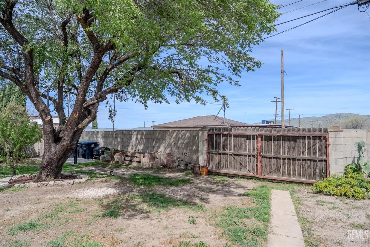 Undisclosed Address Tehachapi, CA 93561 - Photo 36 of 46 a view of a backyard with a large tree