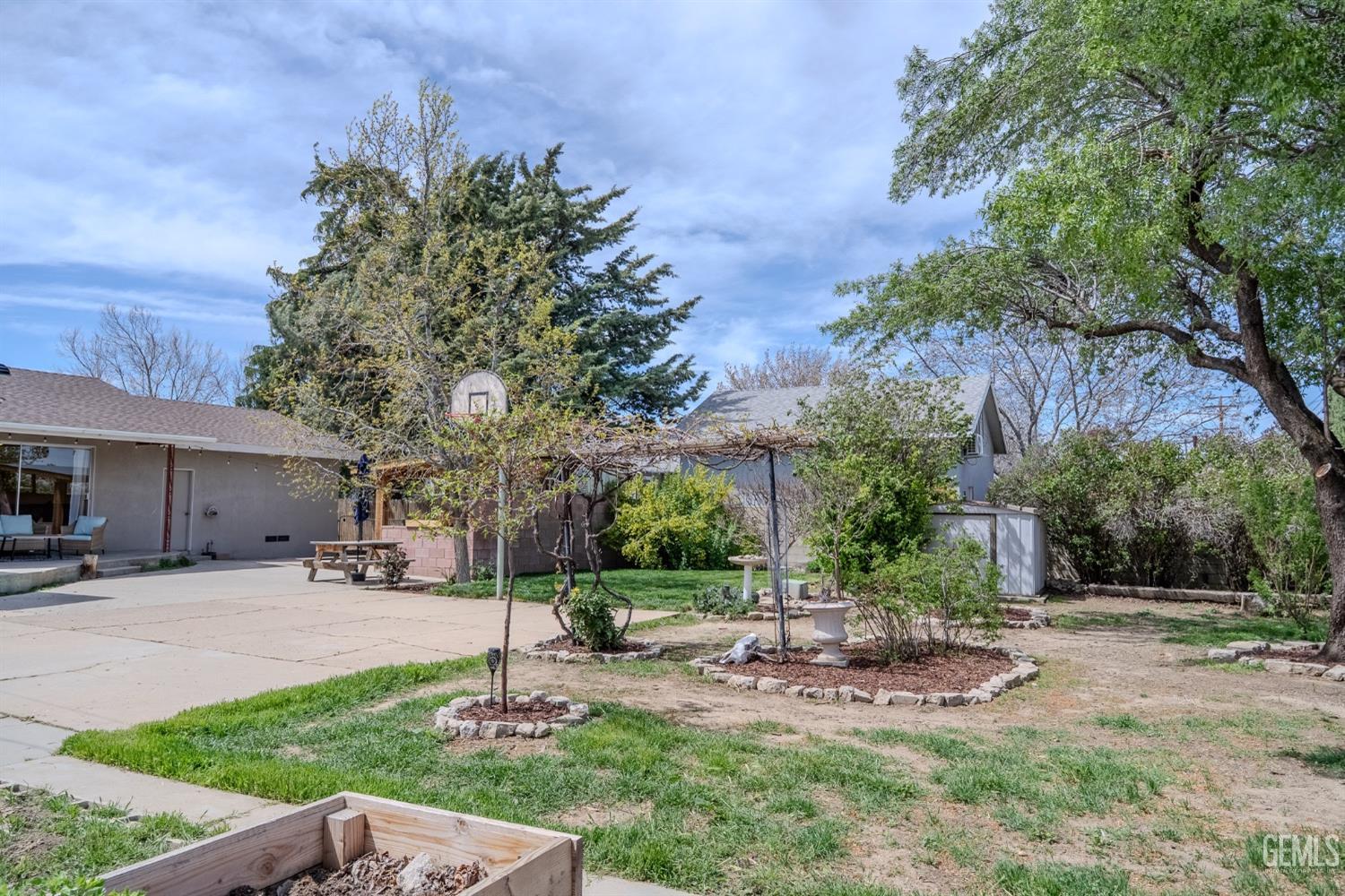 Undisclosed Address Tehachapi, CA 93561 - Photo 38 of 46 a view of a patio with a table and chairs under an umbrella