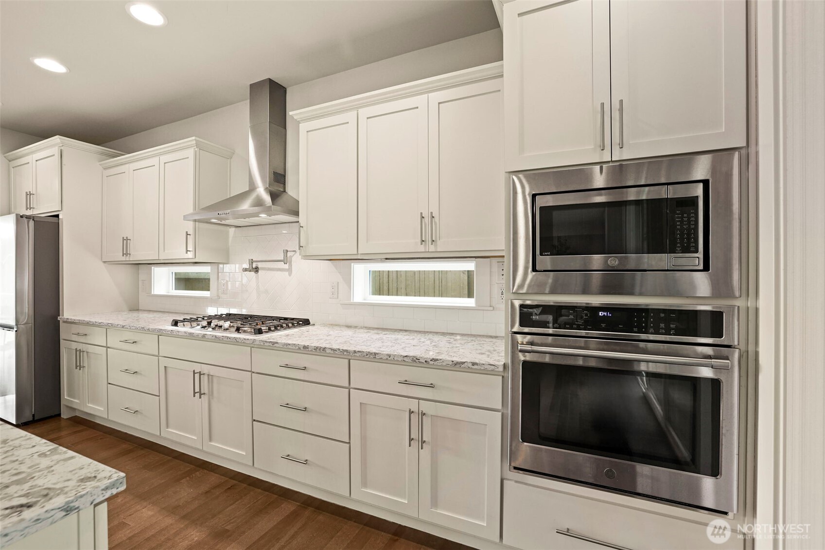 29 242nd Street Southeast Bothell, WA 98021 - Photo 8 of 40 a kitchen with cabinets stainless steel appliances and wooden floor
