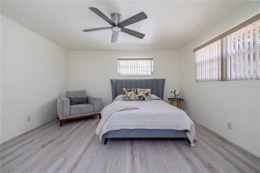 1016 Cherokee Ranch Road Holly Hill, FL 32117 - Photo 14 of 23 a bedroom with a bed a couch and a window