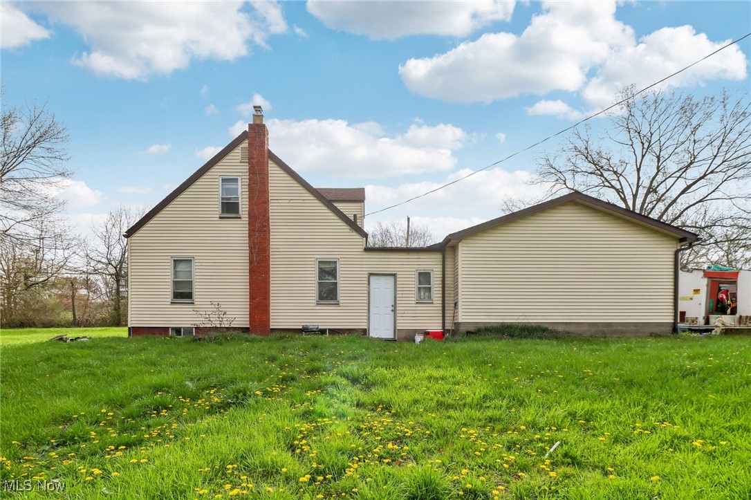944 Bey Road Akron, OH 44312 - Photo 27 of 47 Rear view of house featuring a yard
