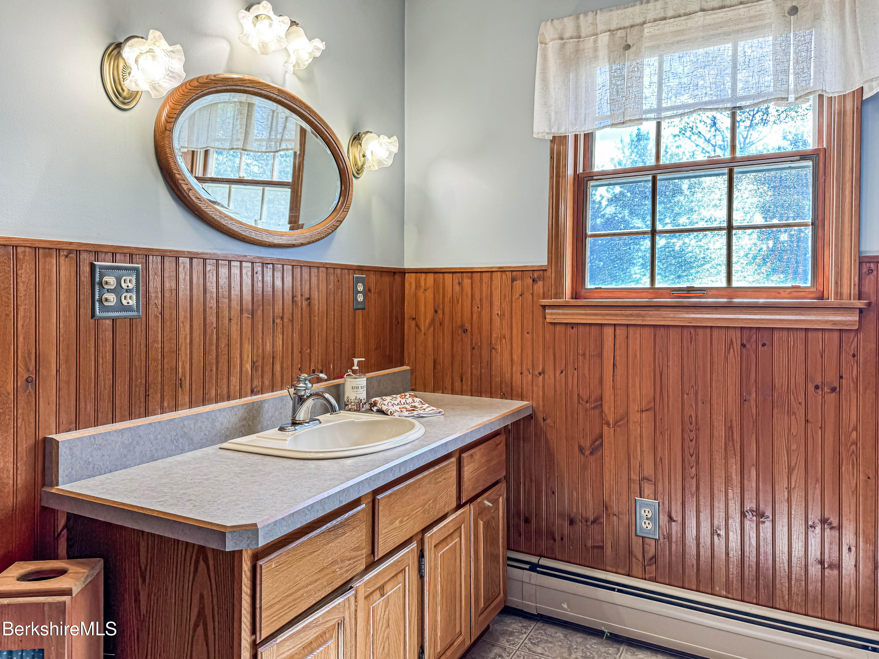 829 Main Road Savoy, MA 01256 - Photo 23 of 38 a bathroom with a sink a mirror and a window