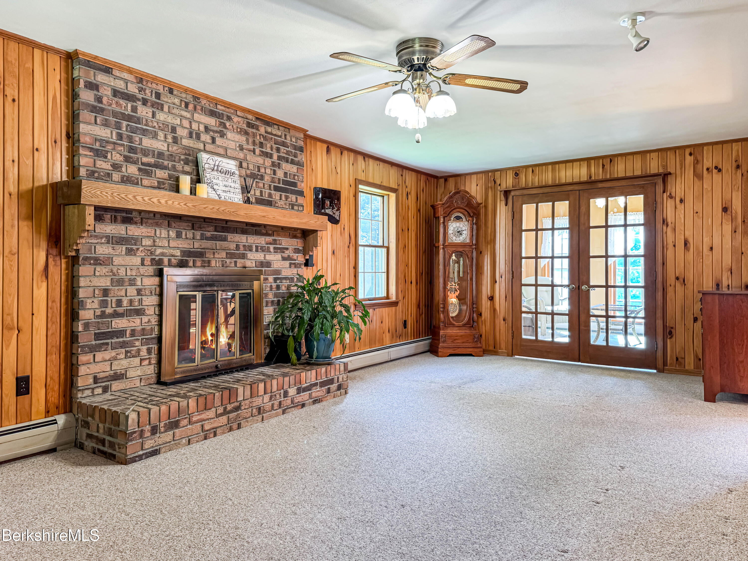 829 Main Road Savoy, MA 01256 - Photo 8 of 38 a view of an empty room with a fireplace and a window