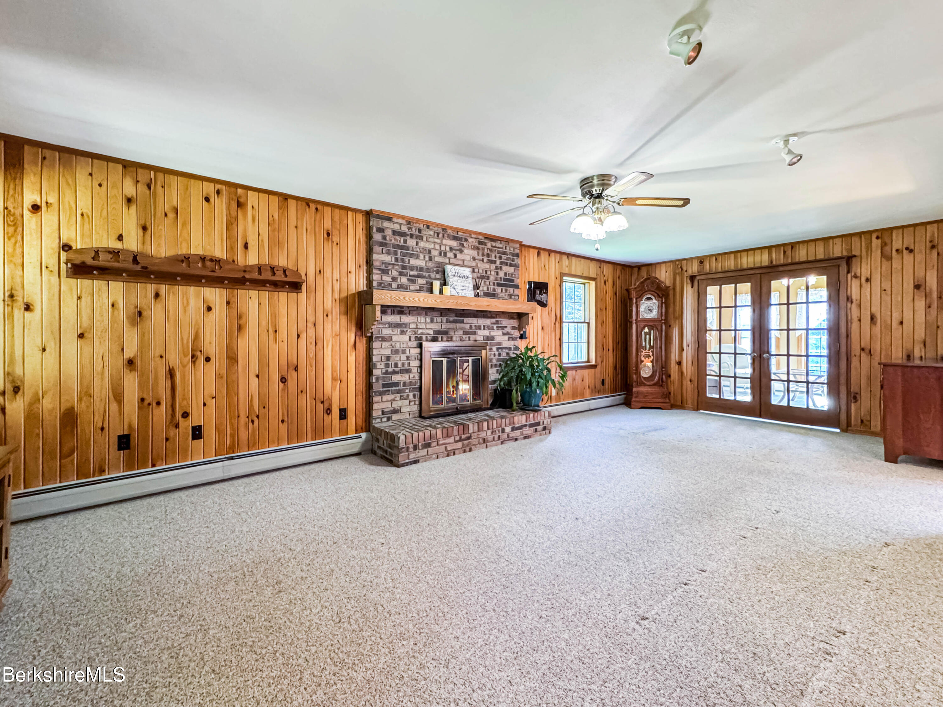 829 Main Road Savoy, MA 01256 - Photo 9 of 38 an empty room with windows & ceiling fan