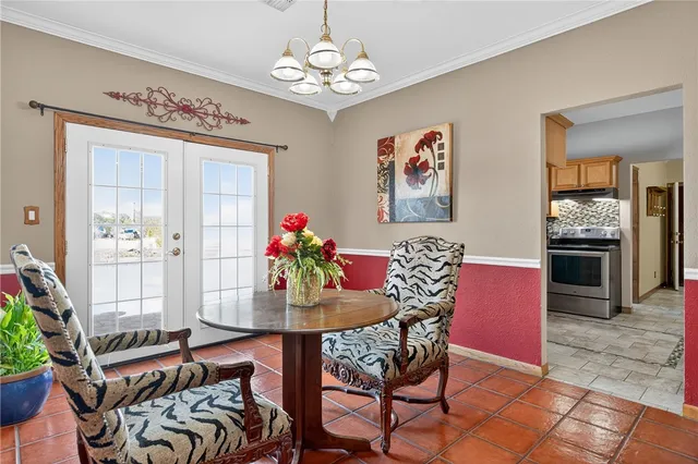 a view of a dining room with furniture and chandelier