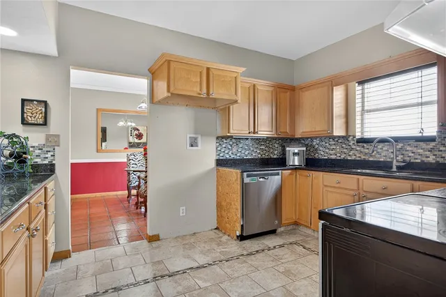 a kitchen with granite countertop a sink and a stove
