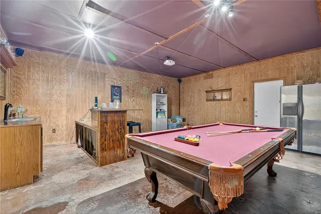 a room with furniture and pool table