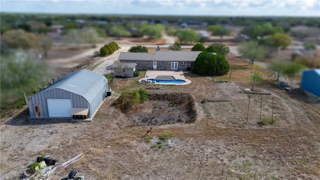 a view of a dry yard with lots of trees