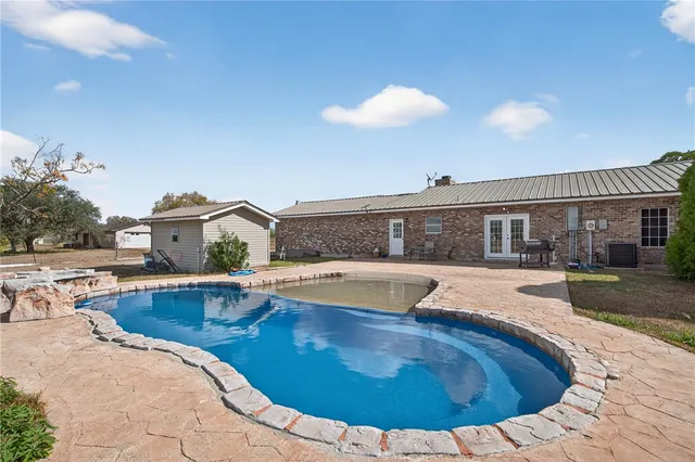 a view of a swimming pool with a lounge chair