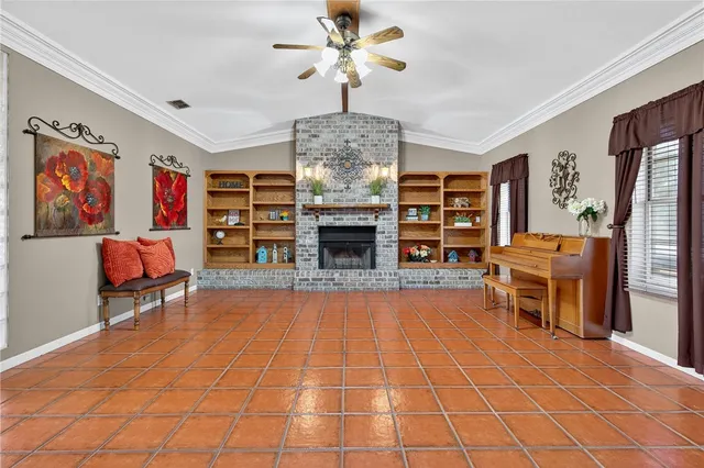 a living room with furniture a fireplace and a chandelier