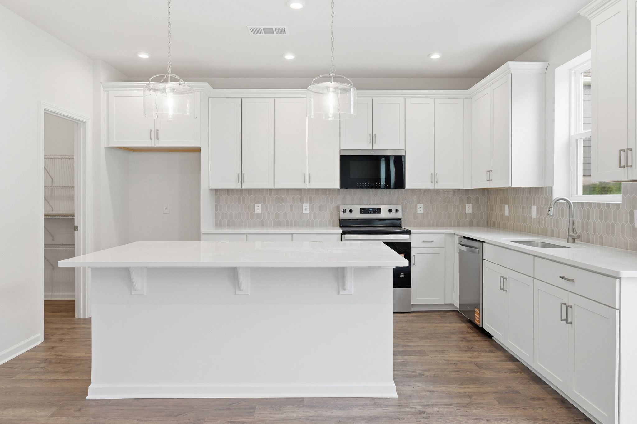 1310 Godwin Road Hermitage, TN 37076 - Photo 13 of 32 a kitchen with stainless steel appliances granite countertop a stove top oven a sink and white cabinets