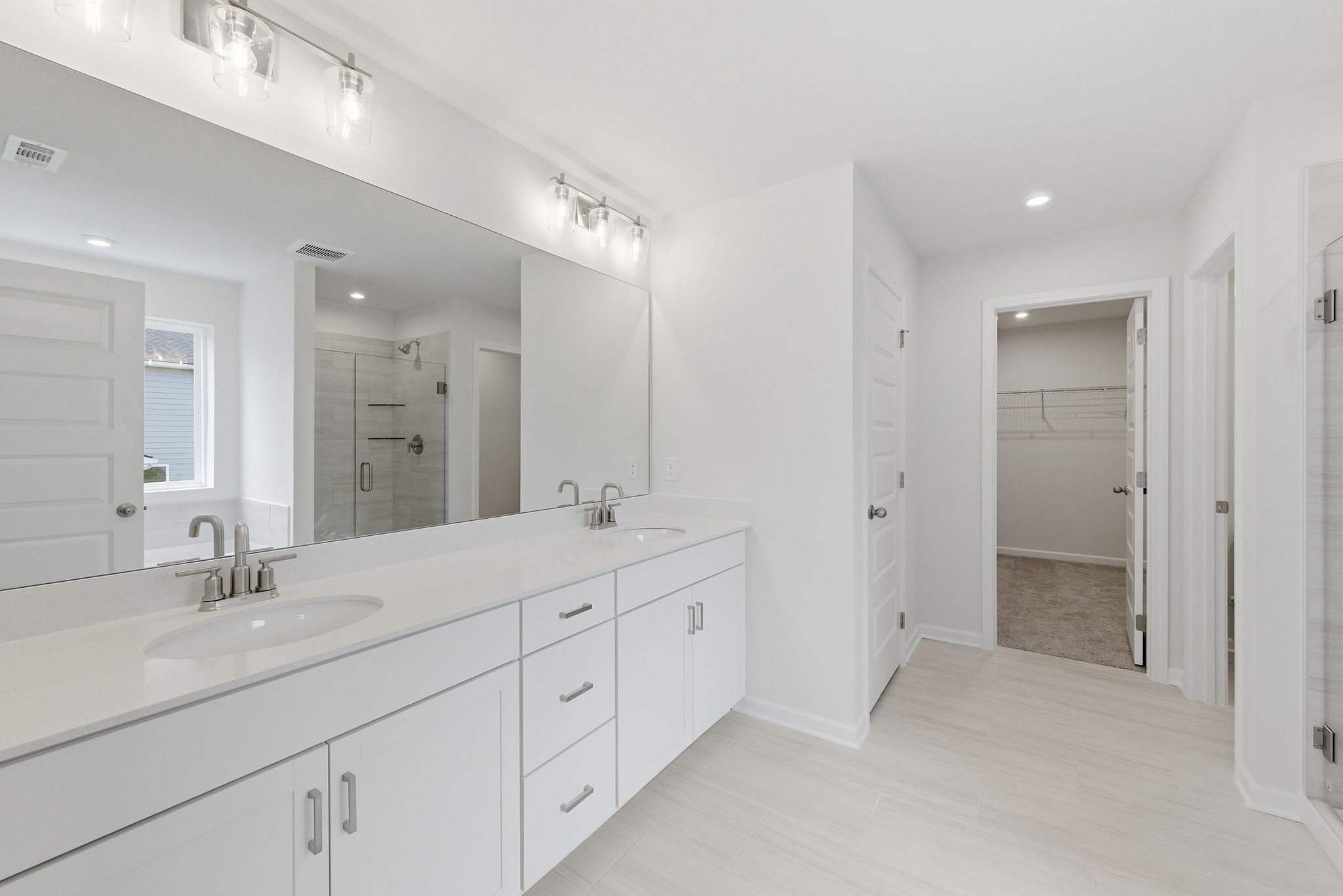 1310 Godwin Road Hermitage, TN 37076 - Photo 21 of 32 a spacious bathroom with a double vanity sink mirror and shower