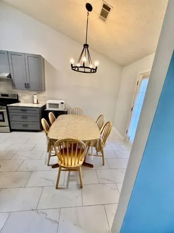 a dining room with furniture and window