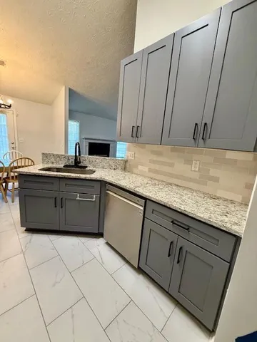 a kitchen with stainless steel appliances granite countertop a sink and a cabinets