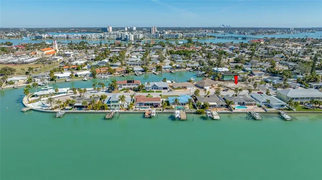 an aerial view of a house with a garden and lake view