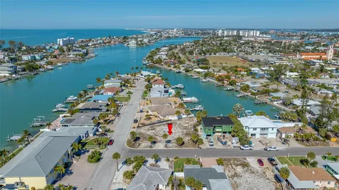 an aerial view of ocean and residential building with outdoor space