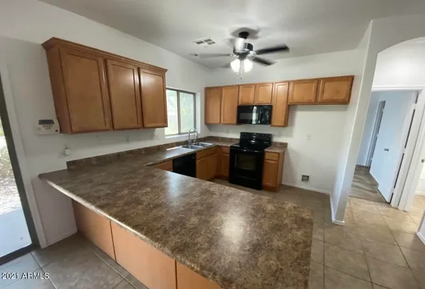 a kitchen with stainless steel appliances granite countertop a sink a stove and a refrigerator
