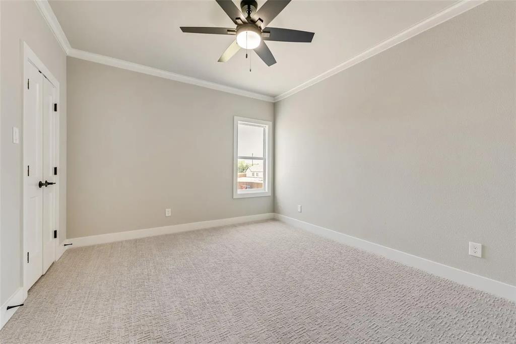 1327 Selby Road Van Alstyne, TX 75495 - Photo 11 of 32 Unfurnished room with light carpet, ornamental molding, and ceiling fan