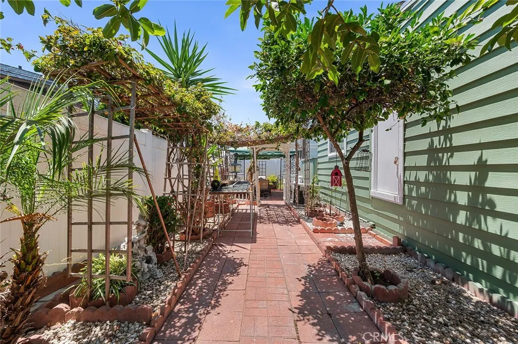 17701 Avalon, Unit SP124 Carson, CA 90746 - Photo 19 of 32 a backyard of a house with barbeque oven table and chairs