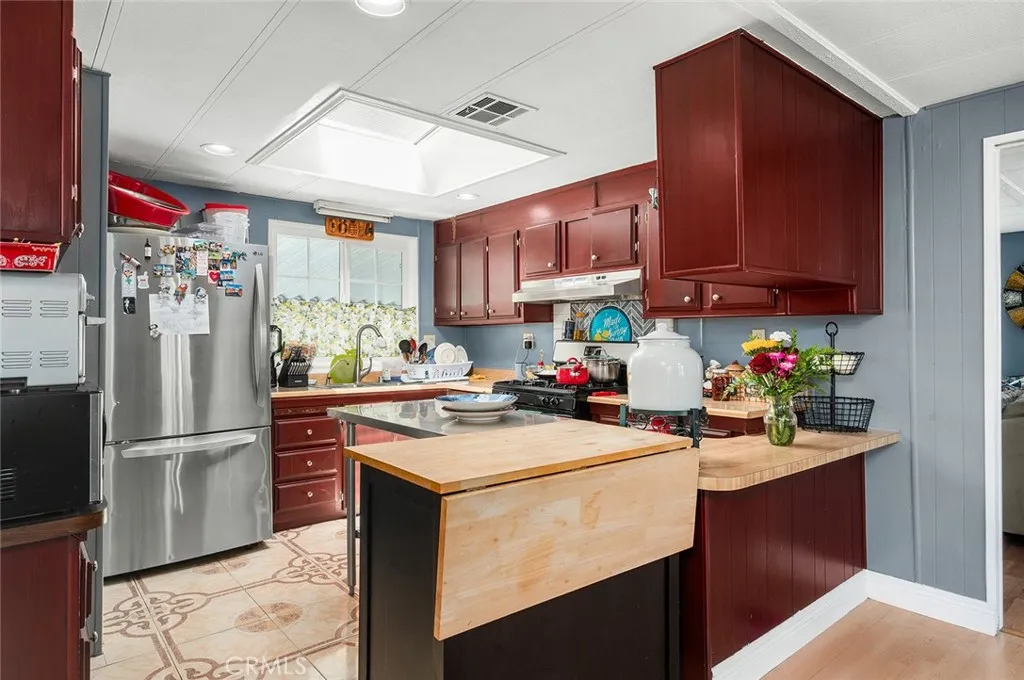 17701 Avalon, Unit SP124 Carson, CA 90746 - Photo 9 of 32 a kitchen with a sink refrigerator and cabinets