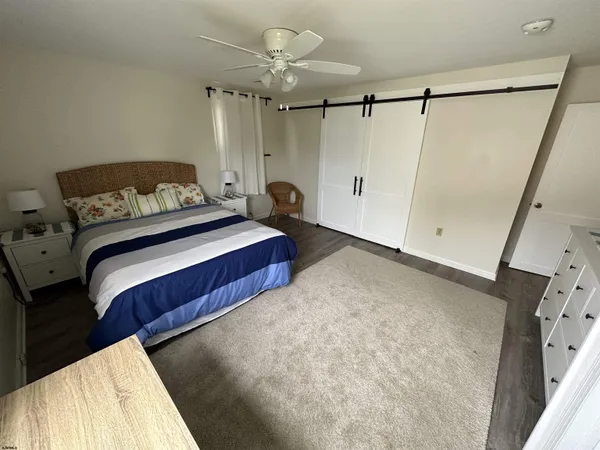 a bedroom with a bed and a mirror