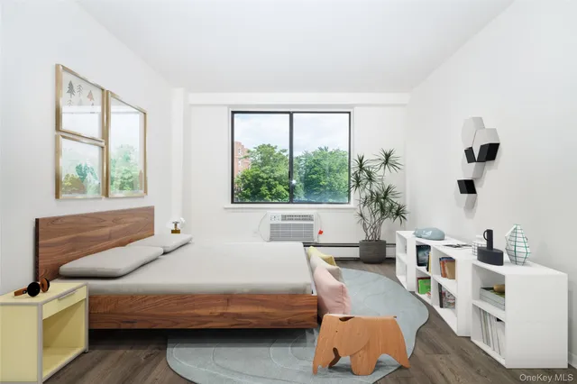 a bedroom with furniture and a large window