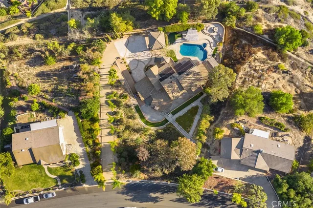 a kitchen with stainless steel appliances granite countertop a refrigerator a stove and a sink with wooden floor