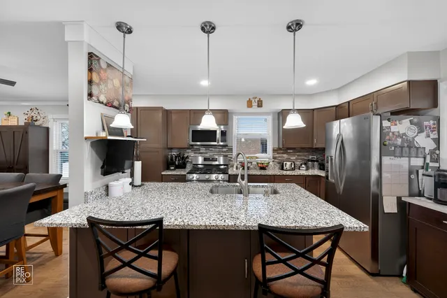 a kitchen with sink cabinets and stainless steel appliances