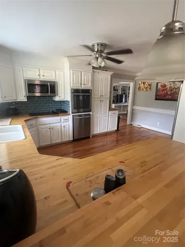 a view of a kitchen with stainless steel appliances