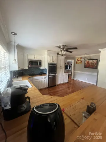 a room with gym equipment and wooden floor