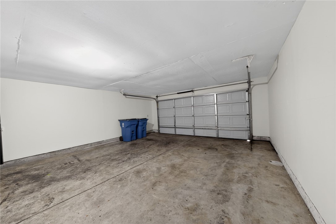 6070 Charlesgate Road Huber Heights, OH 45424 - Photo 6 of 29 An empty garage with a concrete floor awaits your vehicles and storage needs.