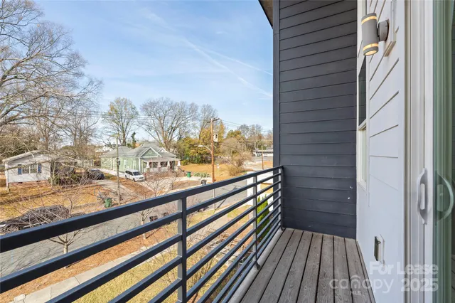 a view of a balcony with wooden floor and fence