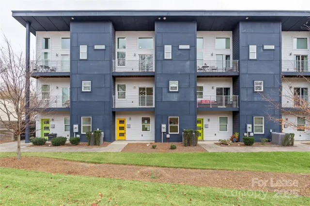 a view of a brick building next to a yard