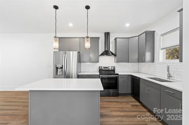 a kitchen with stainless steel appliances a sink stove and refrigerator