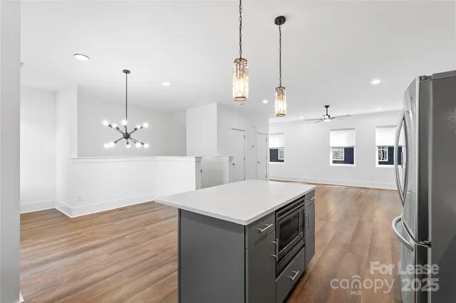 a kitchen with a sink and chandelier