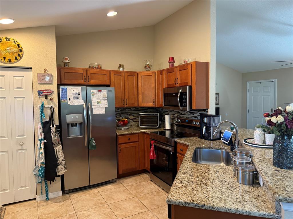 137 Juniper Loop Ocala, FL 34480 - Photo 12 of 28 a kitchen with stainless steel appliances granite countertop a refrigerator and a stove