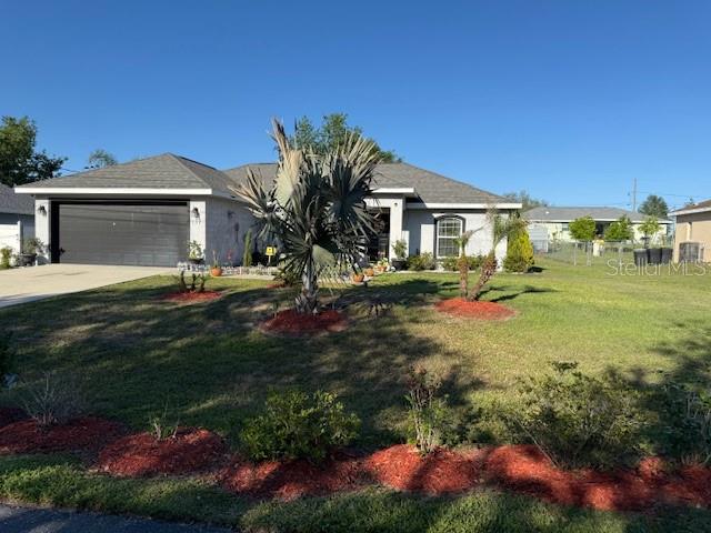 137 Juniper Loop Ocala, FL 34480 - Photo 2 of 28 a front view of a house with a yard and garage
