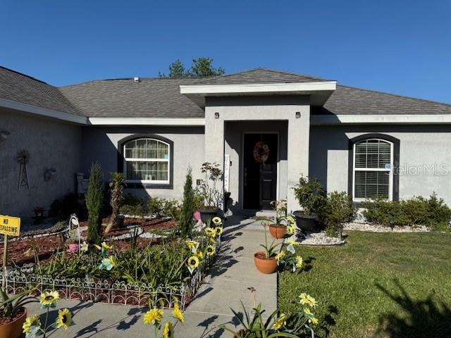 137 Juniper Loop Ocala, FL 34480 - Photo 3 of 28 front view of house with a yard