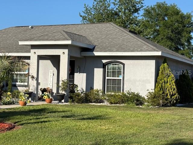 137 Juniper Loop Ocala, FL 34480 - Photo 6 of 28 a front view of a house with garden