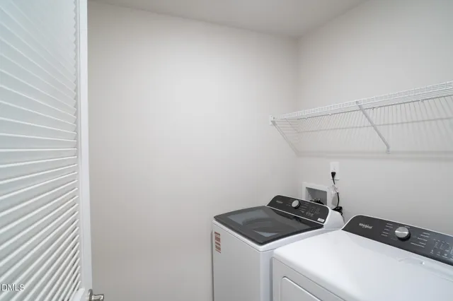 a view of storage and utility room with washer and dryer