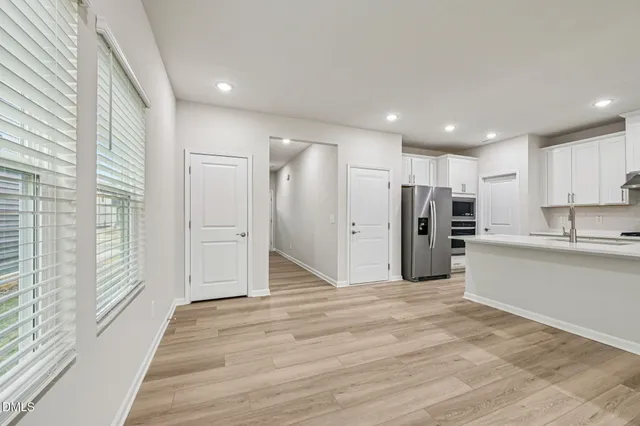 a view of an empty room with wooden floor