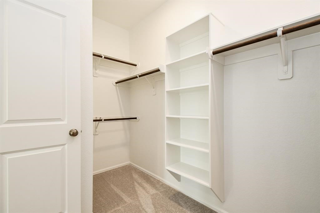 2932 Tantara Drive Katy, TX 77493 - Photo 19 of 34 a view of walk in closet with empty racks