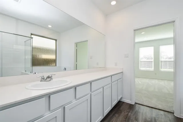 a spacious bathroom with a shower and a sink