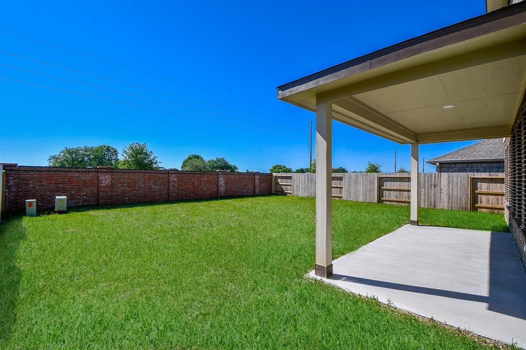 2932 Tantara Drive Katy, TX 77493 - Photo 33 of 34 a view of a backyard with table and chairs with wooden fence