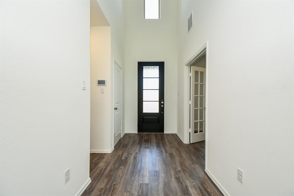 2932 Tantara Drive Katy, TX 77493 - Photo 4 of 34 an empty room with wooden floor and windows