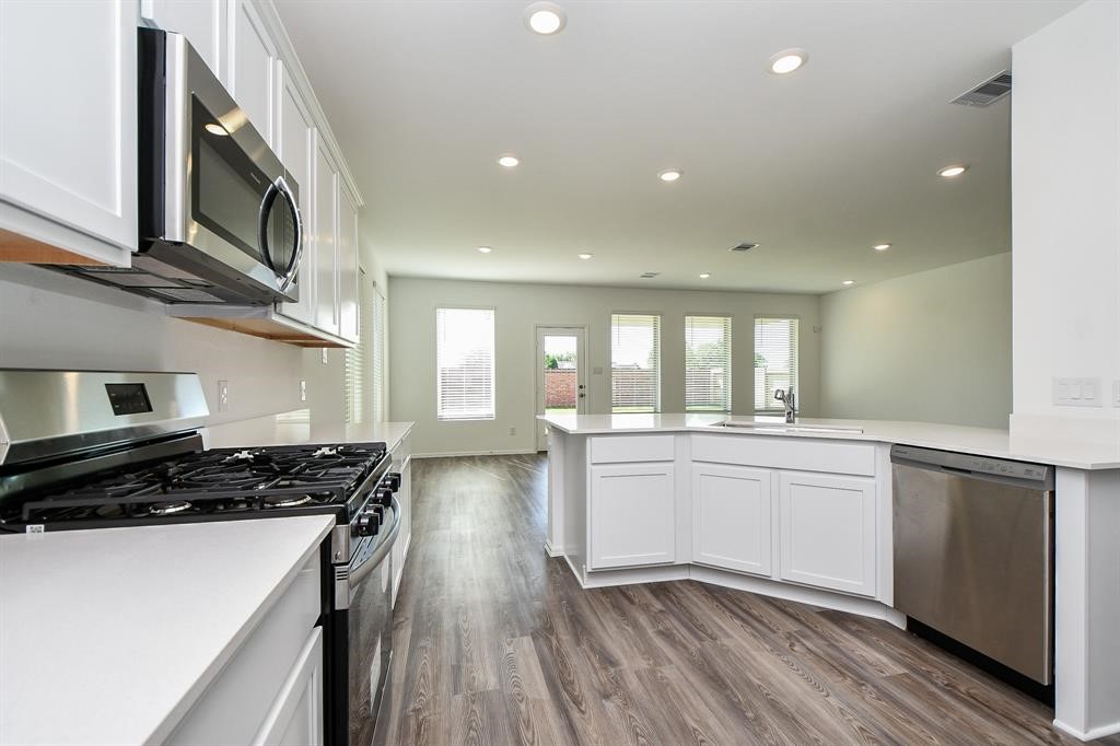 2932 Tantara Drive Katy, TX 77493 - Photo 10 of 34 a kitchen with stainless steel appliances a stove sink and cabinets